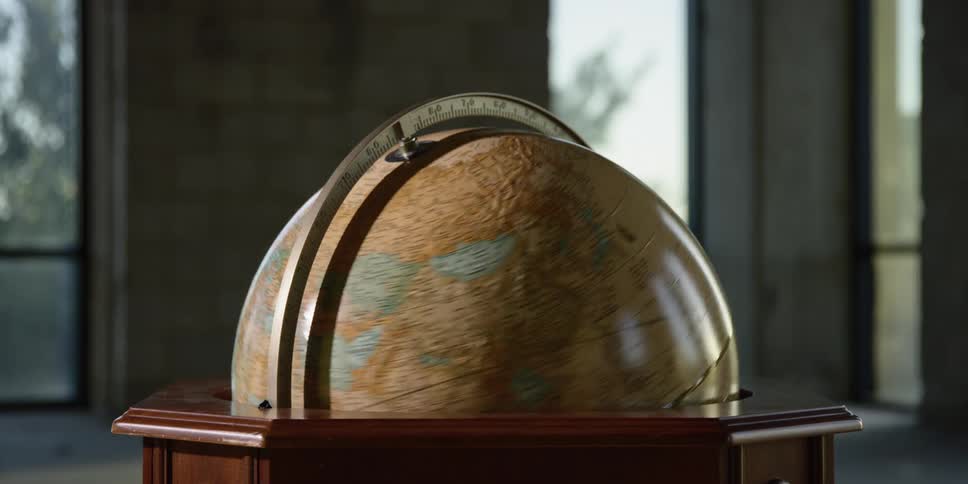 A globe spins and rotates indoors