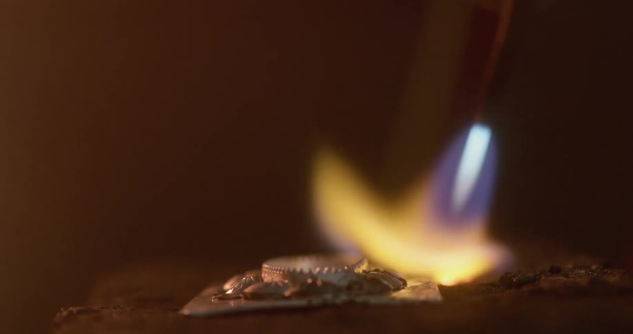 Metal is melted with a blowtorch