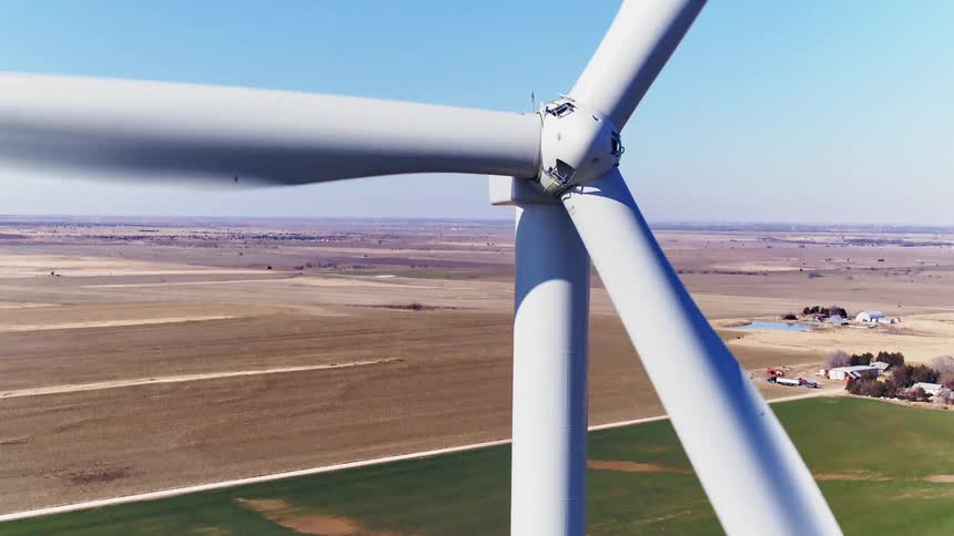 A wind turbine in a large flat field