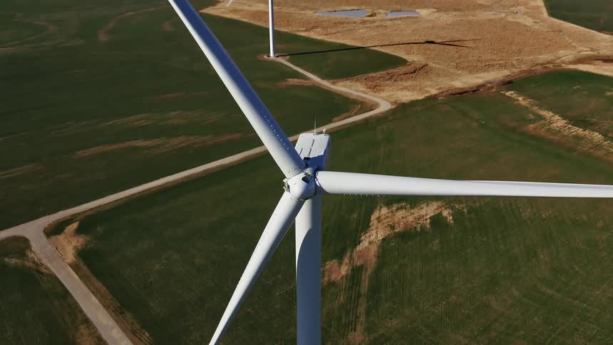 A large windmill is on the long field