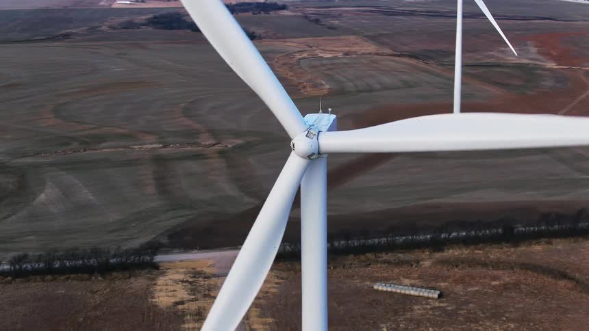 Aerial view of wind turbines spinning around in the wind farm