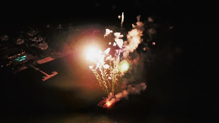 Fireworks lighting up the night sky on the water