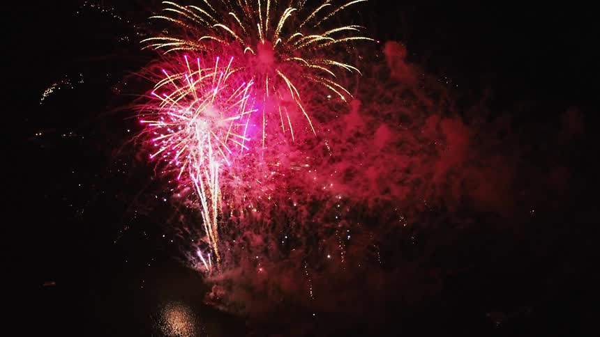 Fireworks display fires off and fades in night sky