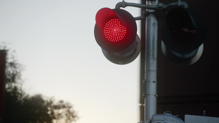 Lights flashing as a train drives by