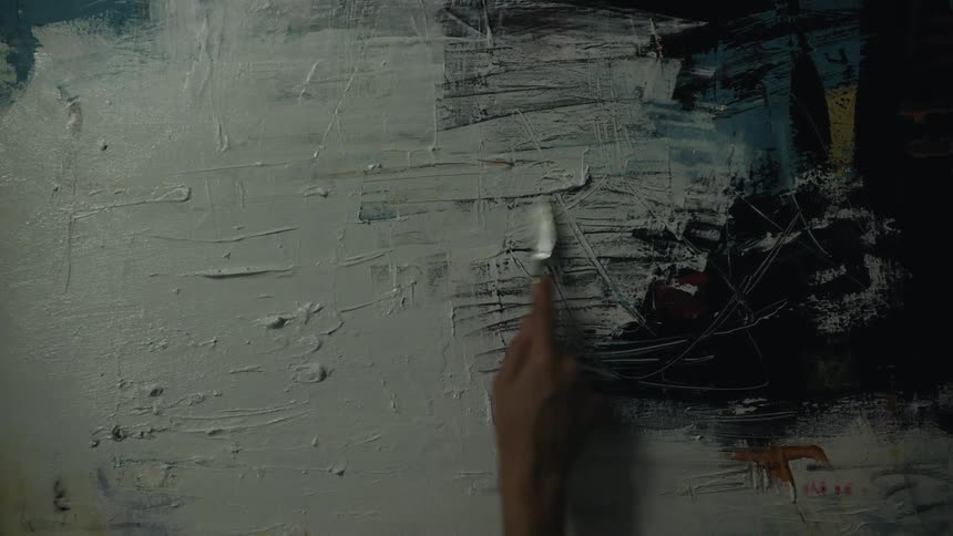A person is painting on a canvas