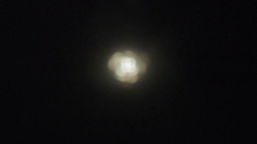 A light flashes on the dark water