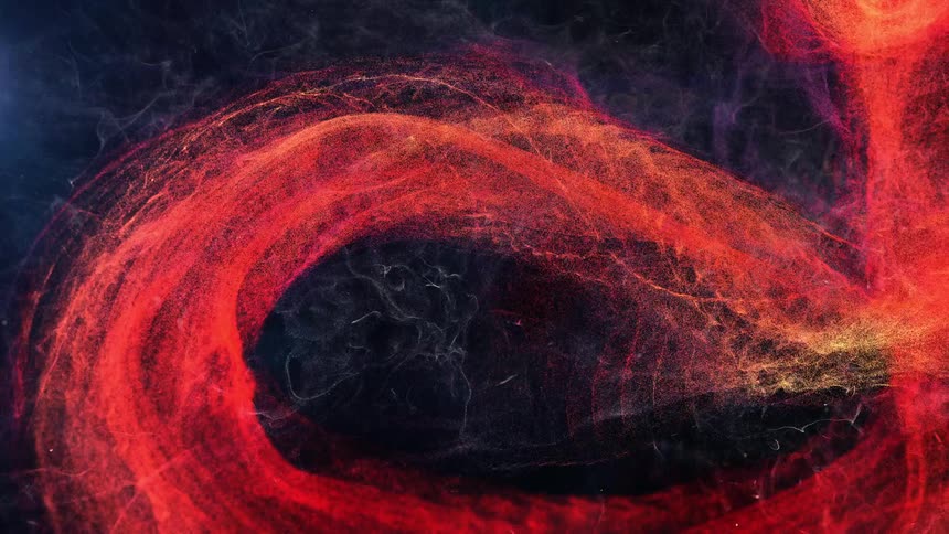 A flame spins around in the dark