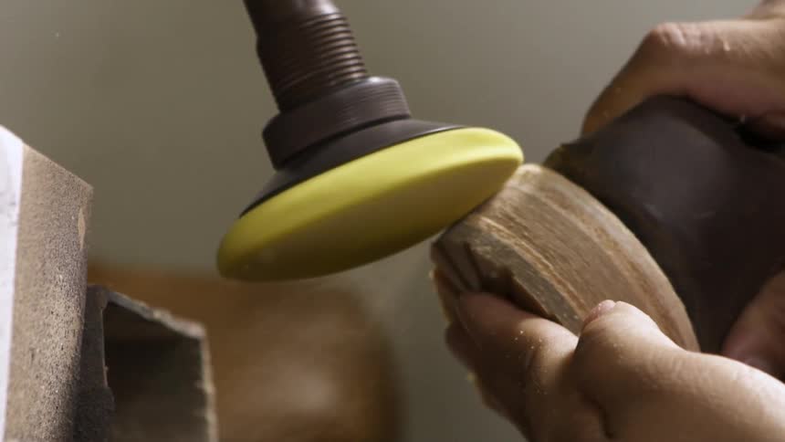 A person is working using a machine to work on a boot