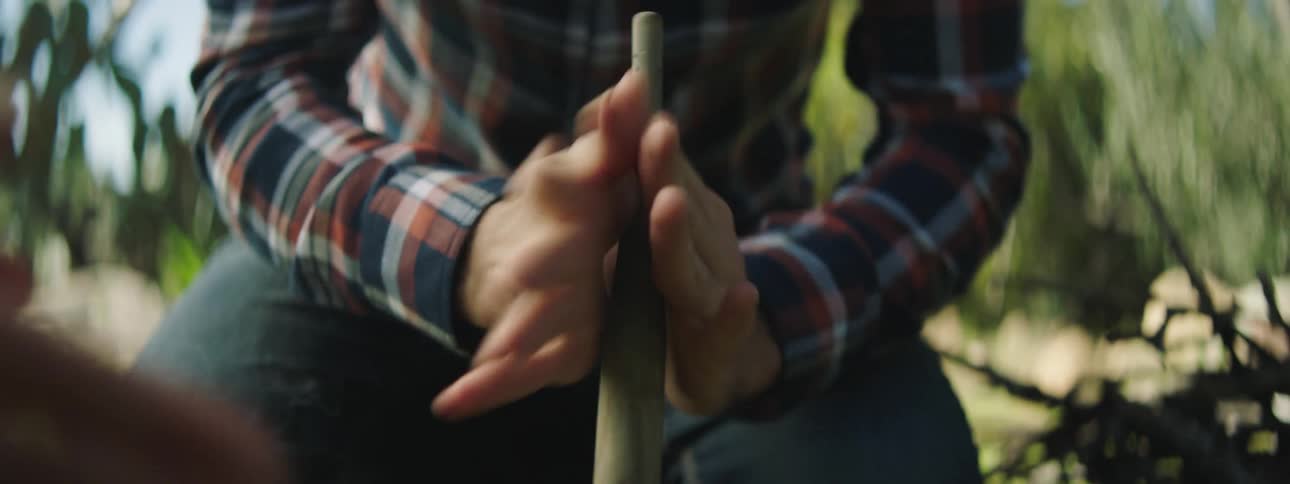 A man is starting a campfire