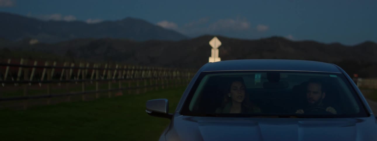 Car driving on a rural road in the dark hours of the morning