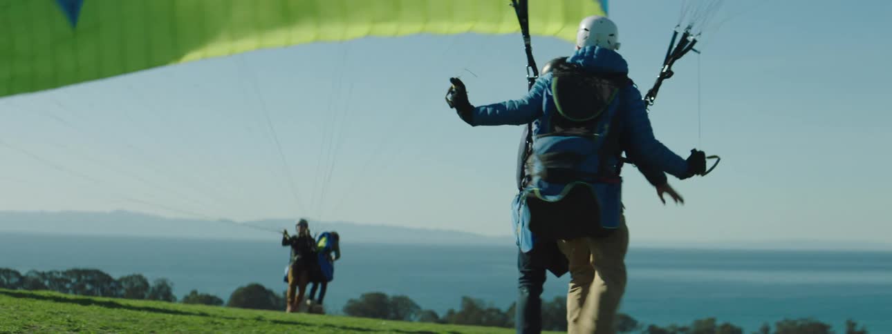 People lift off their hang gliders