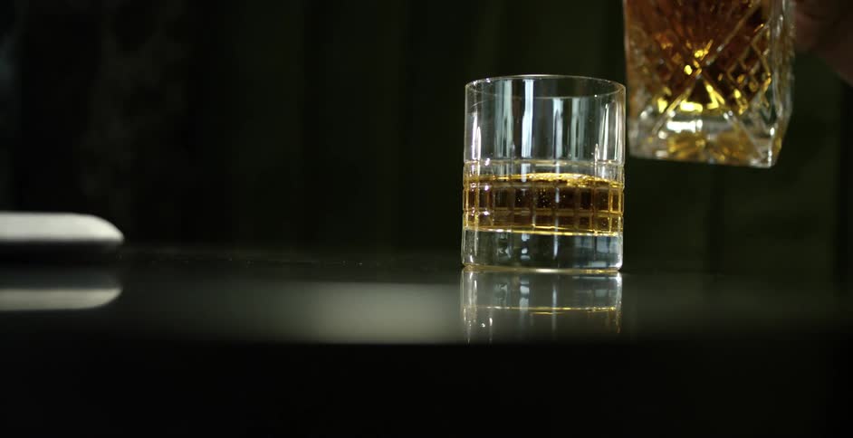 Whiskey is poured into a glass