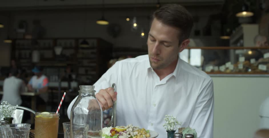 A man eats a meal in a restaurant