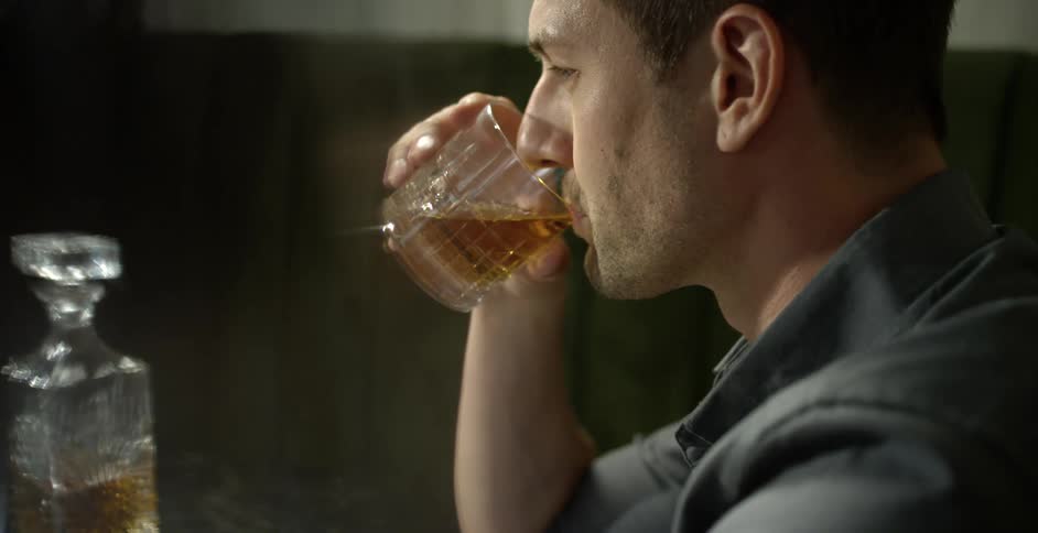 A young man sipping on a drink