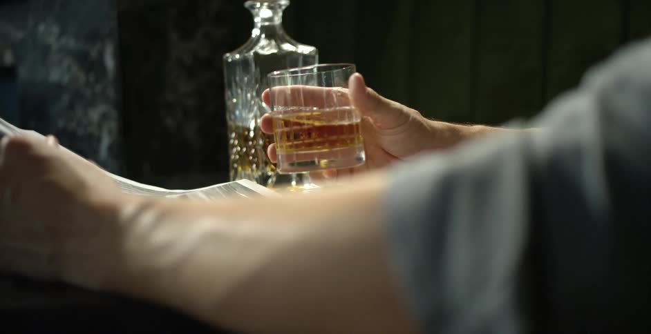 A man is drinking an alcoholic beverage