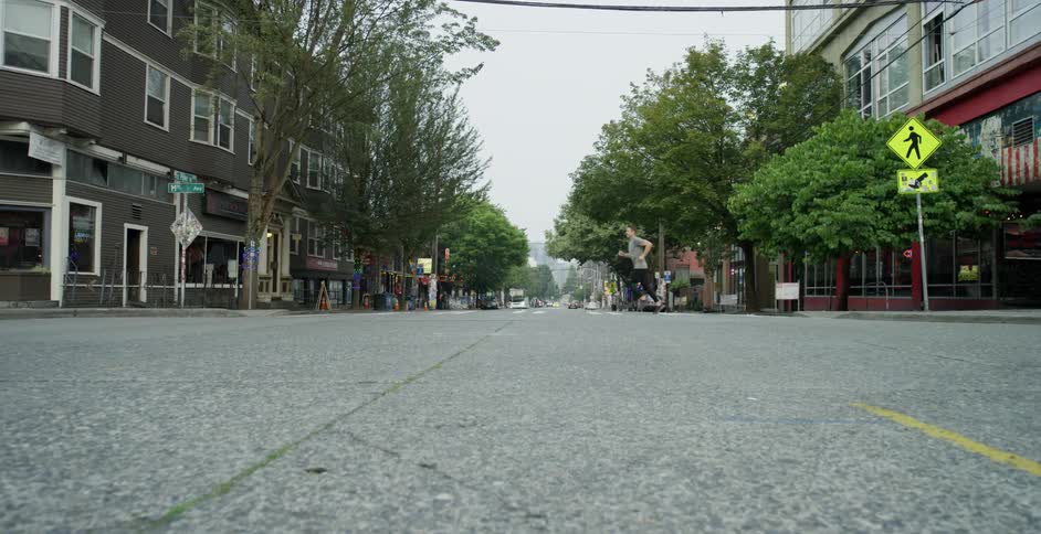 A man runs across the street in a small town