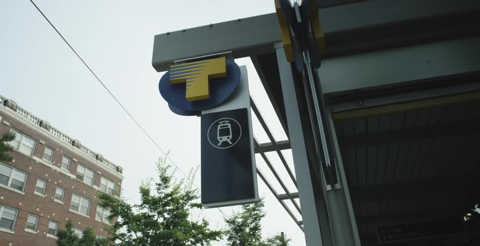 A sign on the building has a train on it