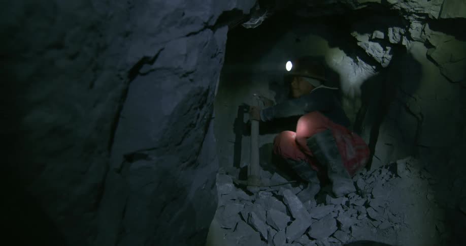 A person is mining in a cave