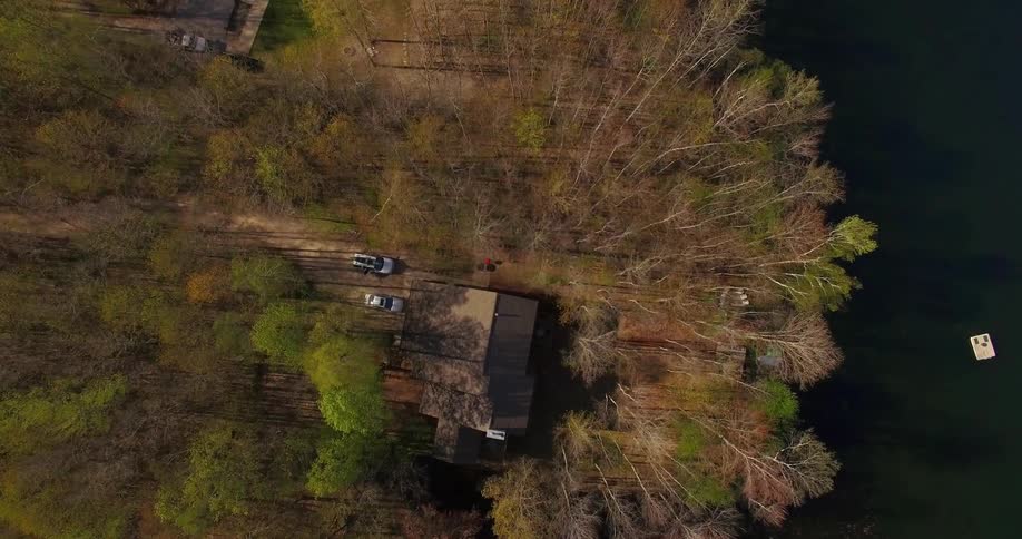 A house sits amid mostly leafless trees