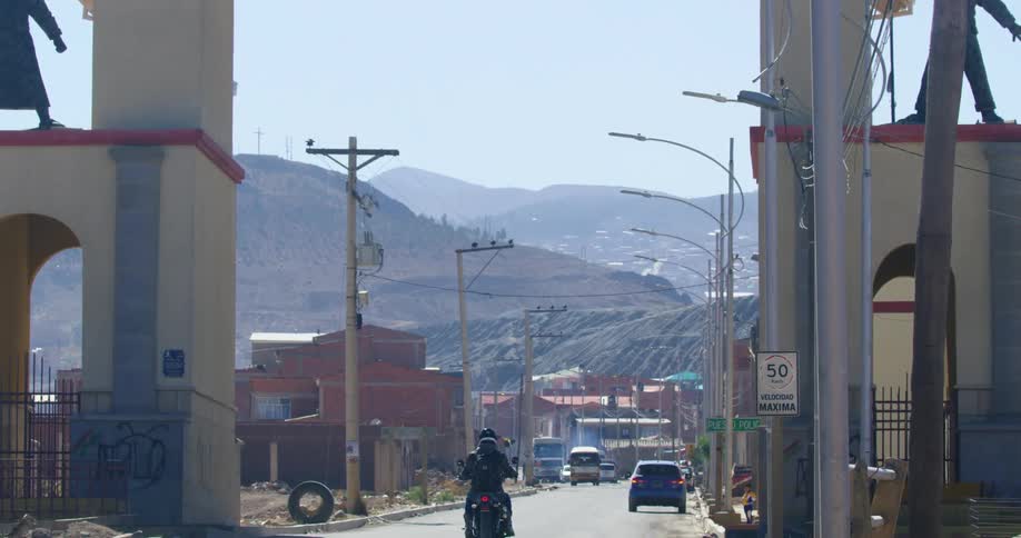 A motorcycle rides into town
