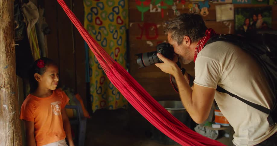A photographer takes photos of a little girl