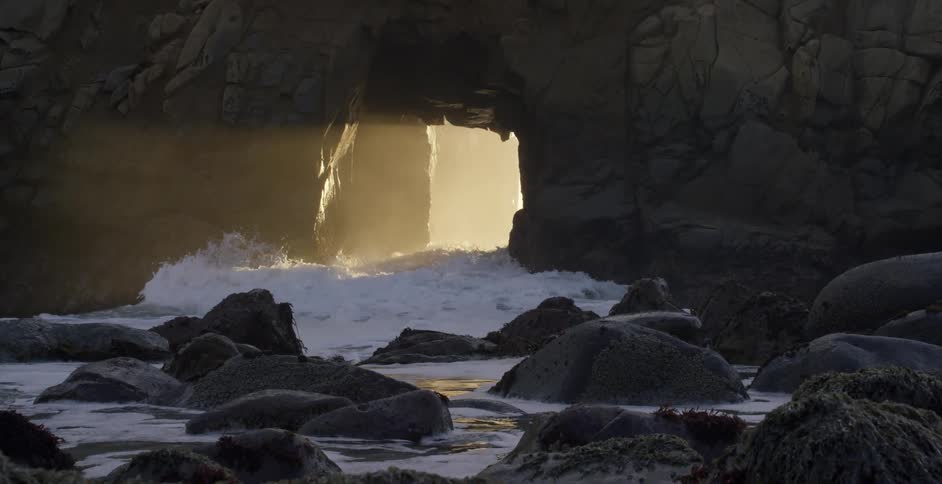 The sun peaks in through the sea cave