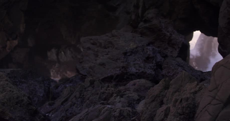The water splashes against the rocks
