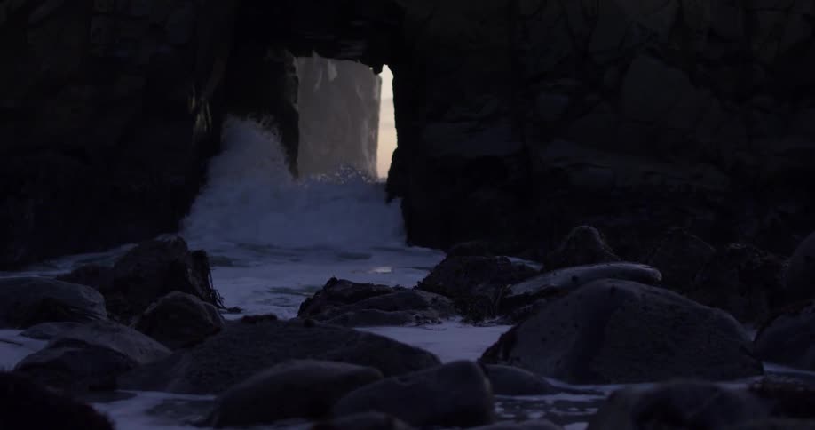 A cave near the coast with waves of water entering through the entrance