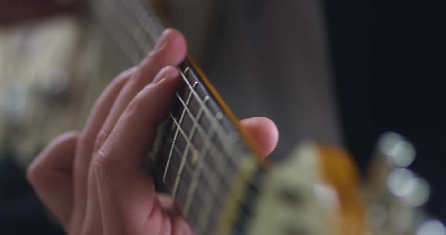 A man playing the guitar inside