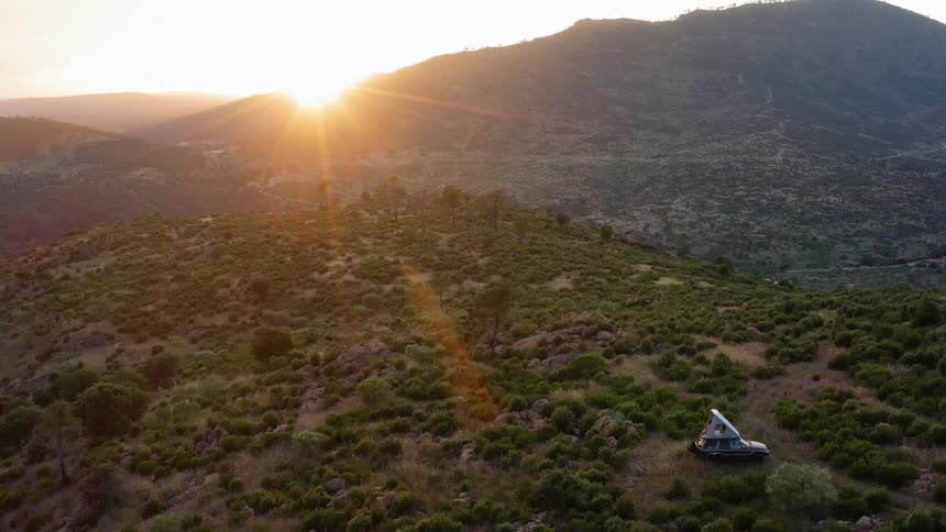 A single vehicle is parked on the mountain