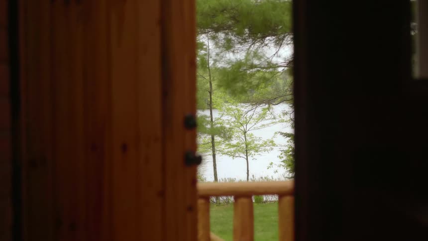 The door at the end of the hall leads to the yard by the lake