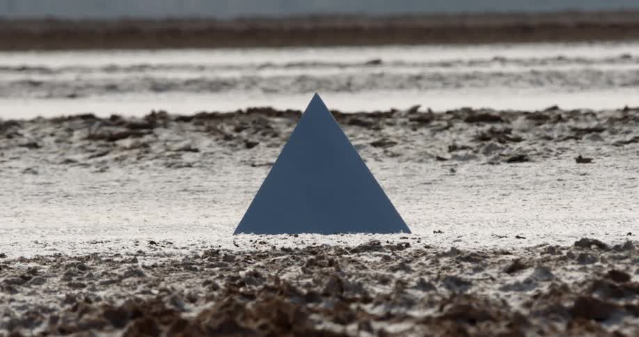 A blue triangle on the shore