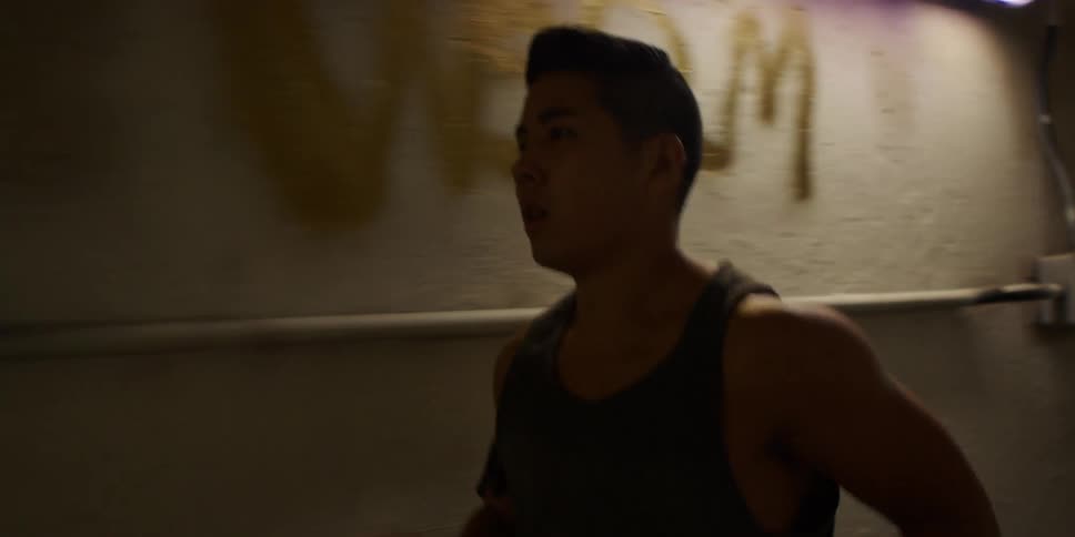 A man is jogging through a tunnel