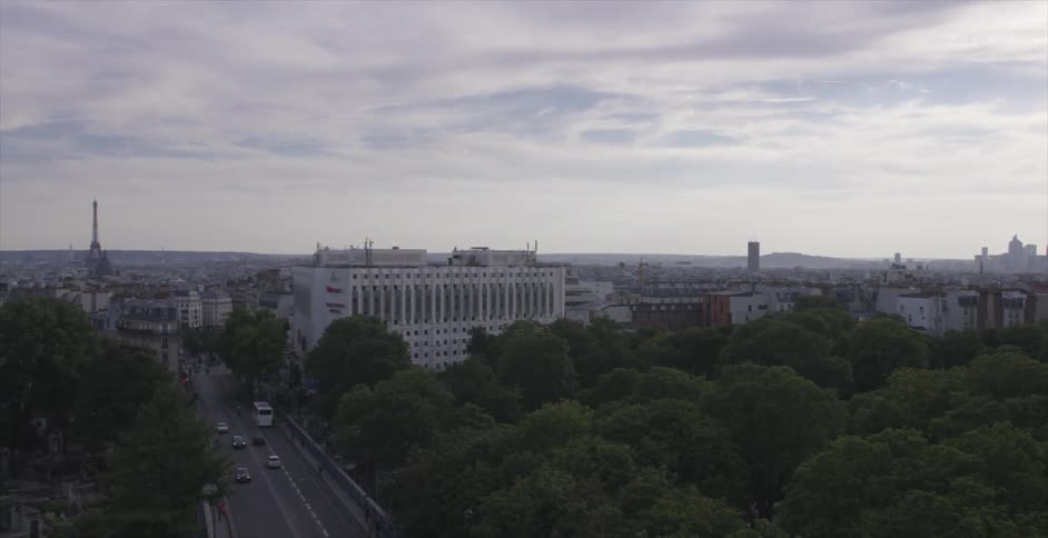 A city surrounded by trees on a cloudy day