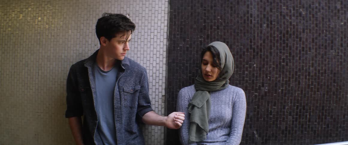 A man and woman are standing outdoors together