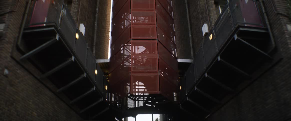 A gated stairwell is between the buildings