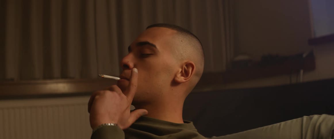 A man is smoking a cigarette