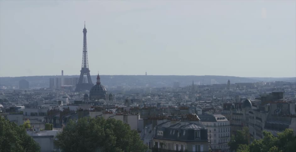 The eiffel tower stands in the distance