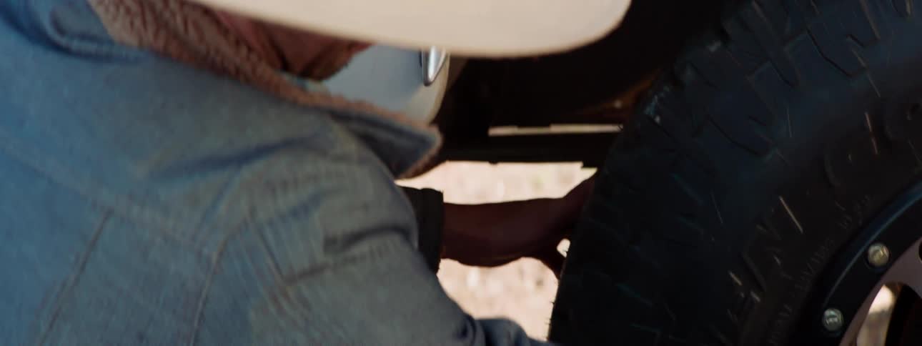 Two men change a tire