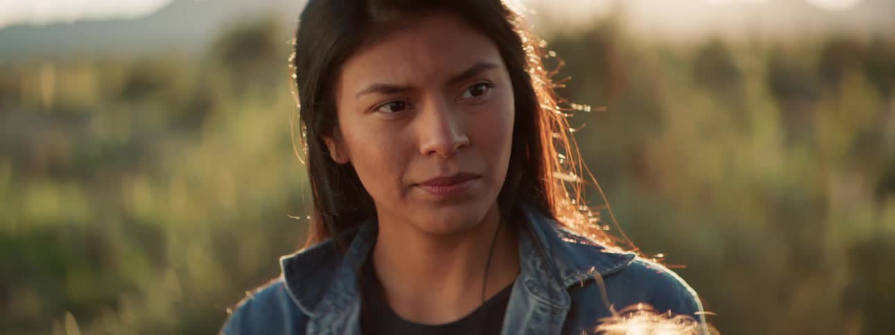 Brunette woman with a denim jacket feels down in the field