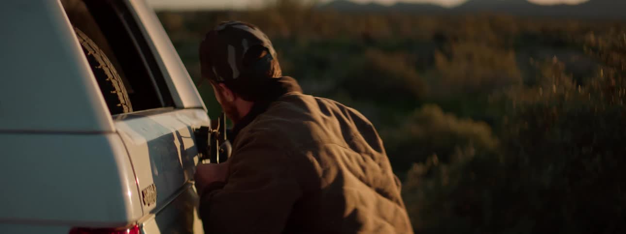 A man closing the back of his truck up