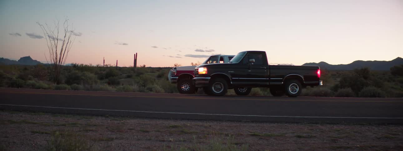 A truck pulls up alongside another on the road