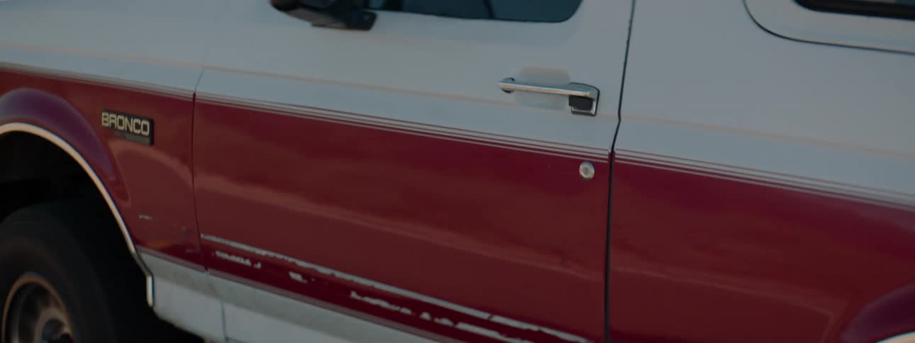 A man is driving a truck in a rural area
