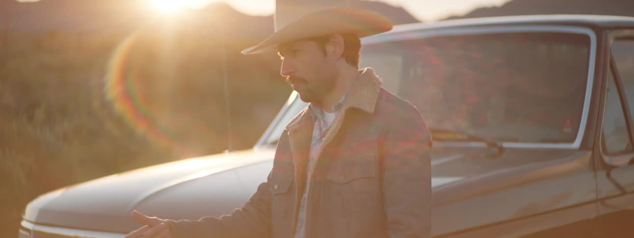 A man walks from his truck talking