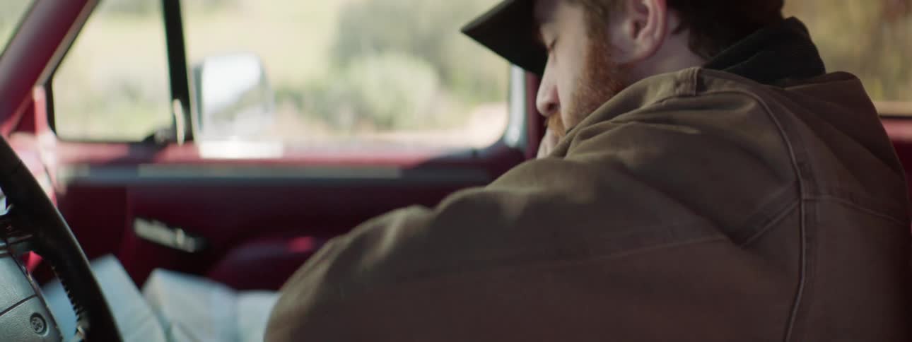 A man talks on his phone while opening a map