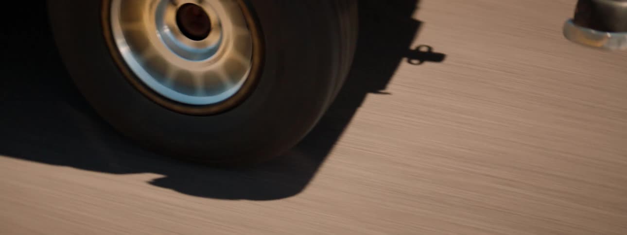 A vehicle driving on the road with trees plants and the sky in the background