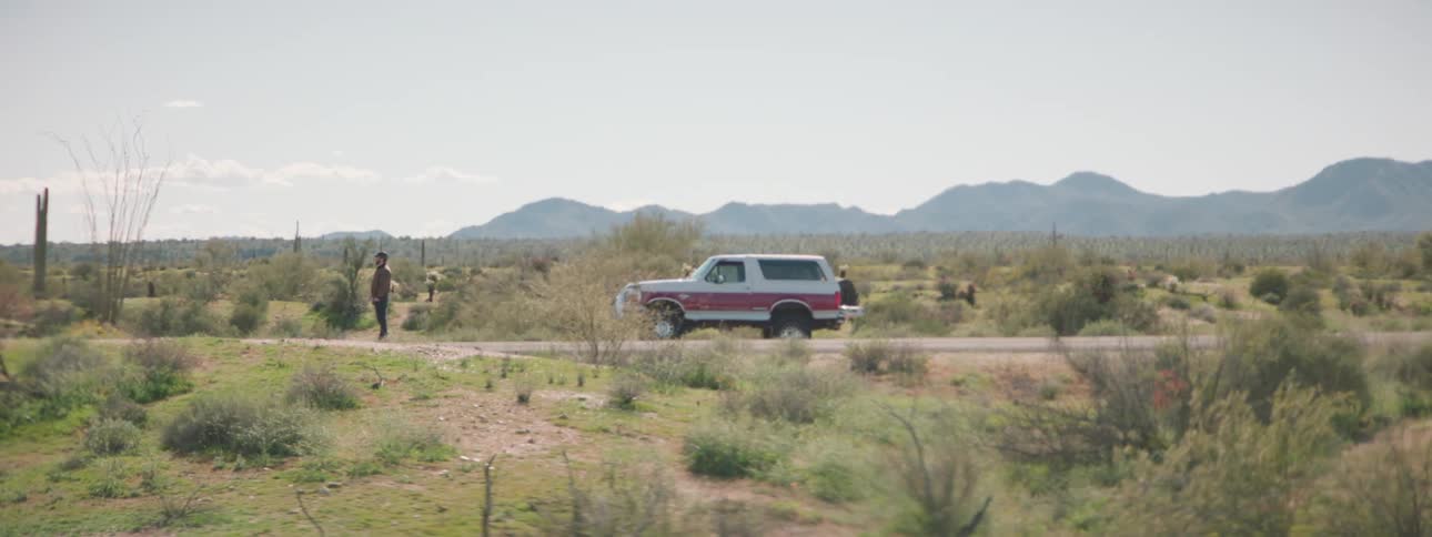 A man walks from his vehicle on the highway