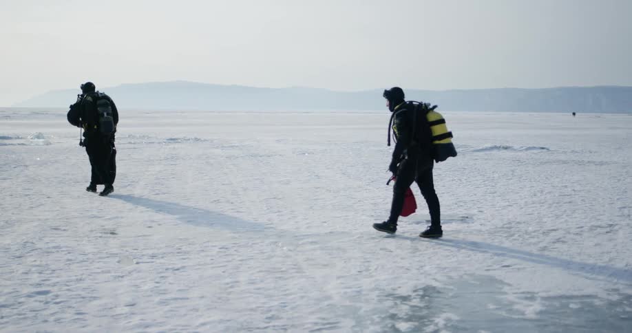 People walking across a frozen lake