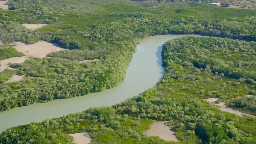 The winding river runs towards the ocean