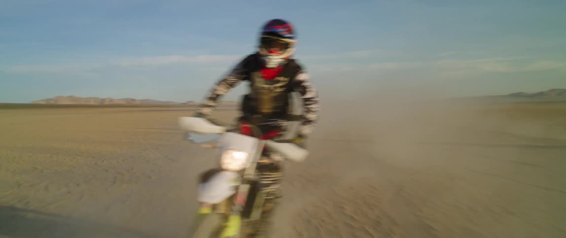 Two people riding dirt bikes